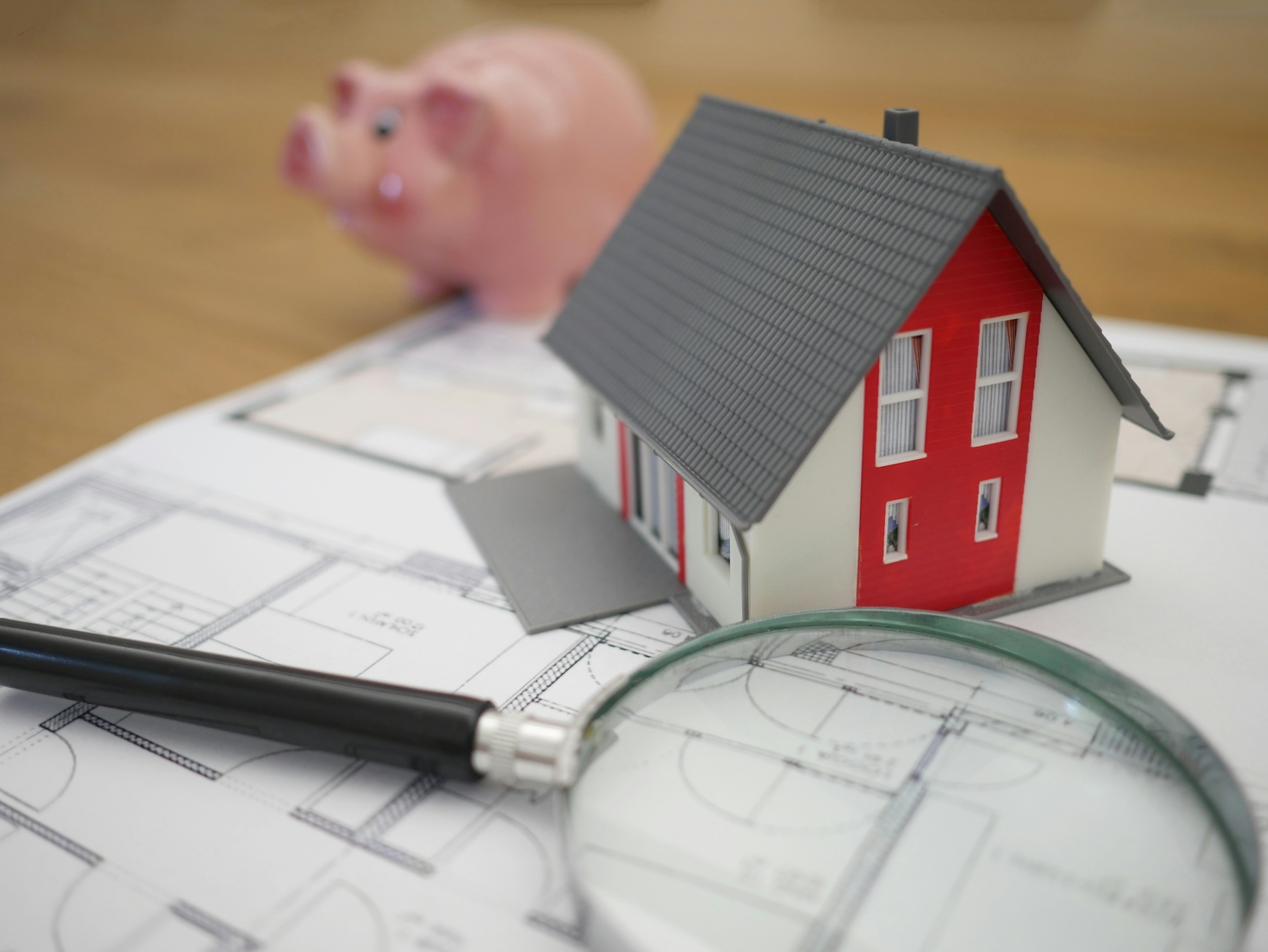 a home on architectural plans with a piggy bank, this is Bernadette Brennan from Premier home finders budget insight into the Australian budget handed down in May 2026