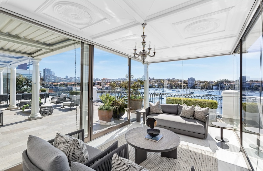 Lounge room looking out to undercover deck with water views accross Sydney Harbour this apartment at 6/9 Elamang Avenue, Kirribilli, NSW 2061 sold in October 2025 for $15m