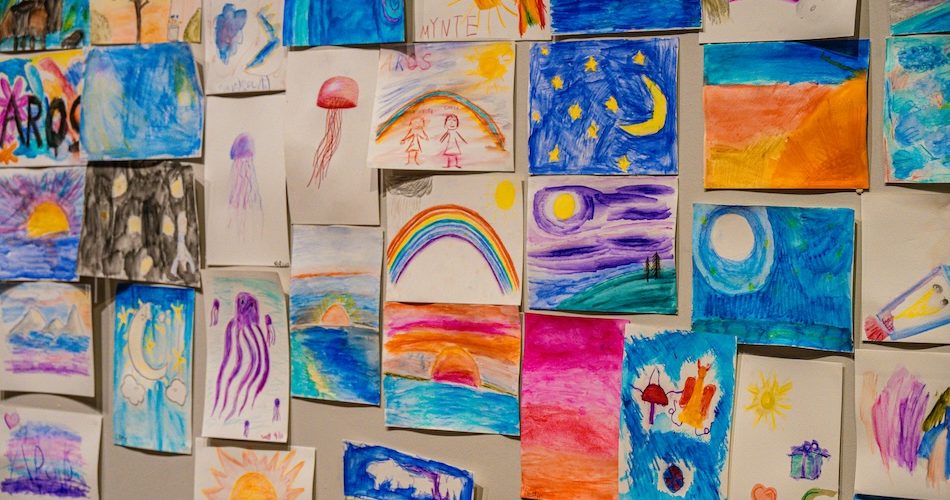 a wall full of colourful childrens paintings at Eastern Suburbs Public School