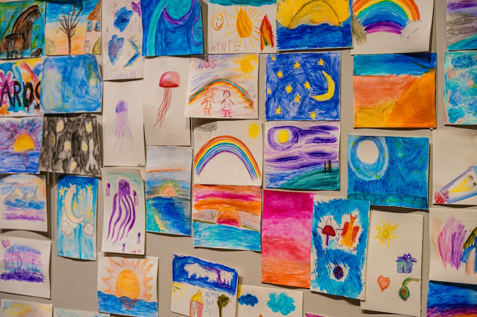 a wall full of colourful childrens paintings at Eastern Suburbs Public School