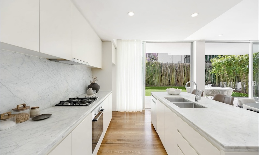 3/19 Young Street Vaucluse NSW 2030 white kitchen with stone splash back and island with double sink this is the top apartment sale in Vaucluse in September 2026